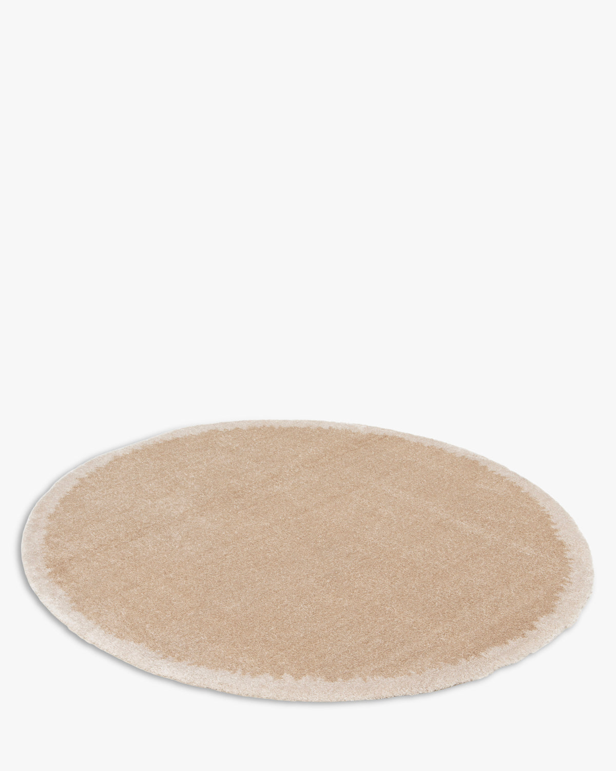 tapis rond NIMBUS beige au contour écru dégradé, posé à plat et vu en perspective