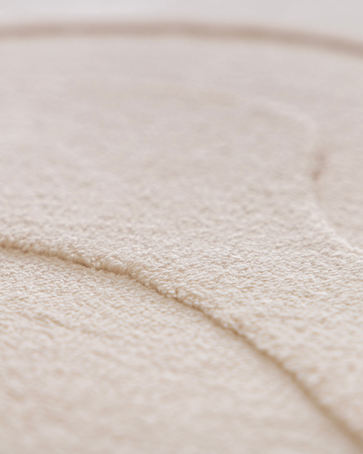 gros plan sur le détail tissé sombre et la lisière surjetée écrue d'un tapis de salon Ikat